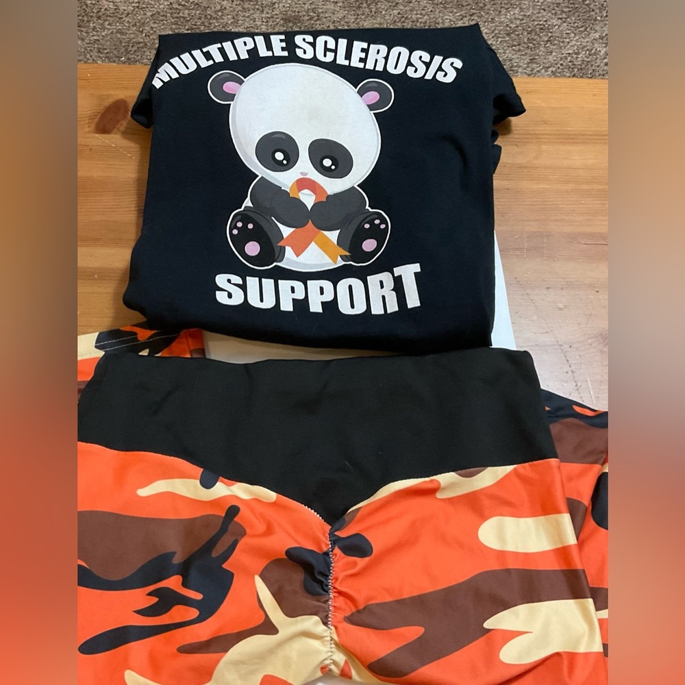 Orange and black jungle/camo legging and black panda tee shirt for charity.